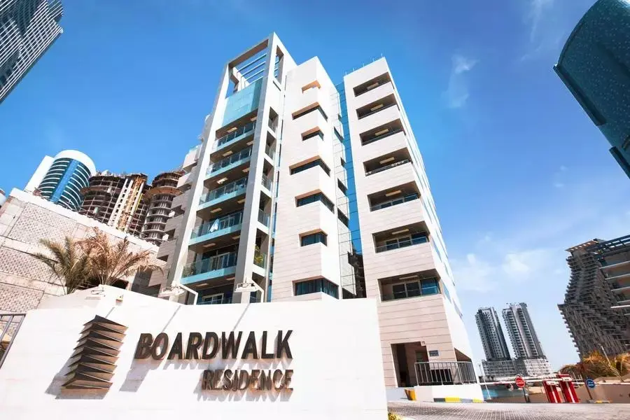 Modern 9-story facade of Boardwalk Residence overlooking the tranquil waterfront promenade in City of Lights, Al Reem Island.