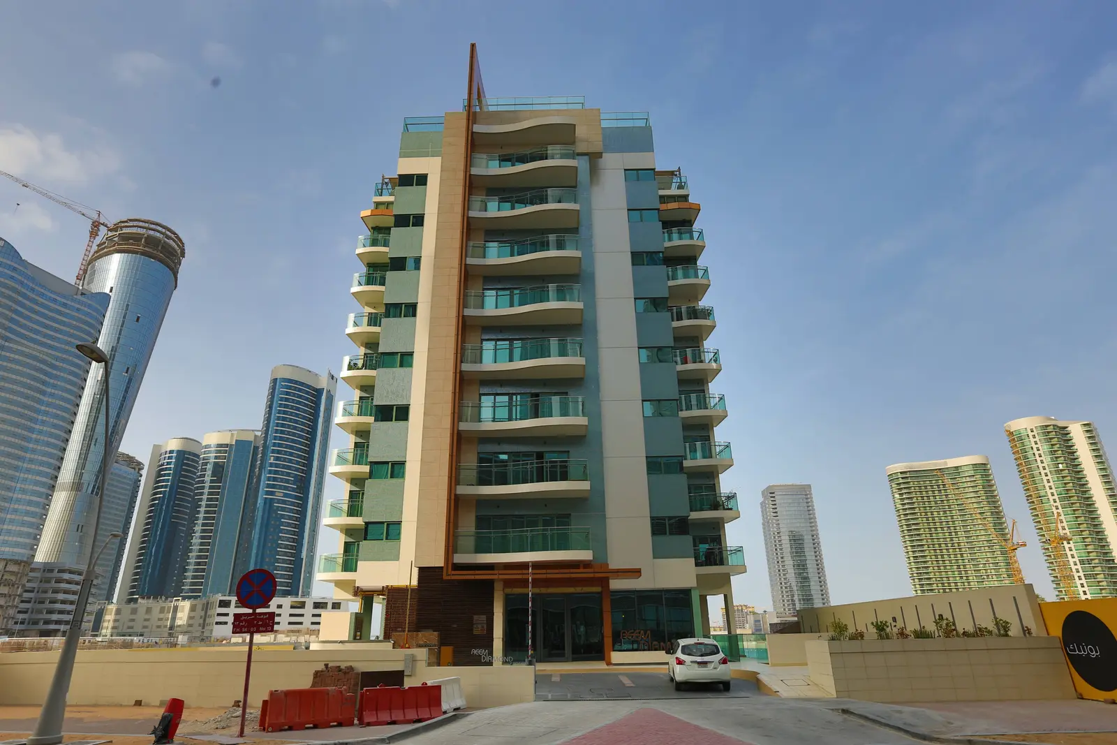 Modern glass exterior architecture of Parkside Towers in Shams Abu Dhabi on Al Reem Island surrounded by landscaped pathways
