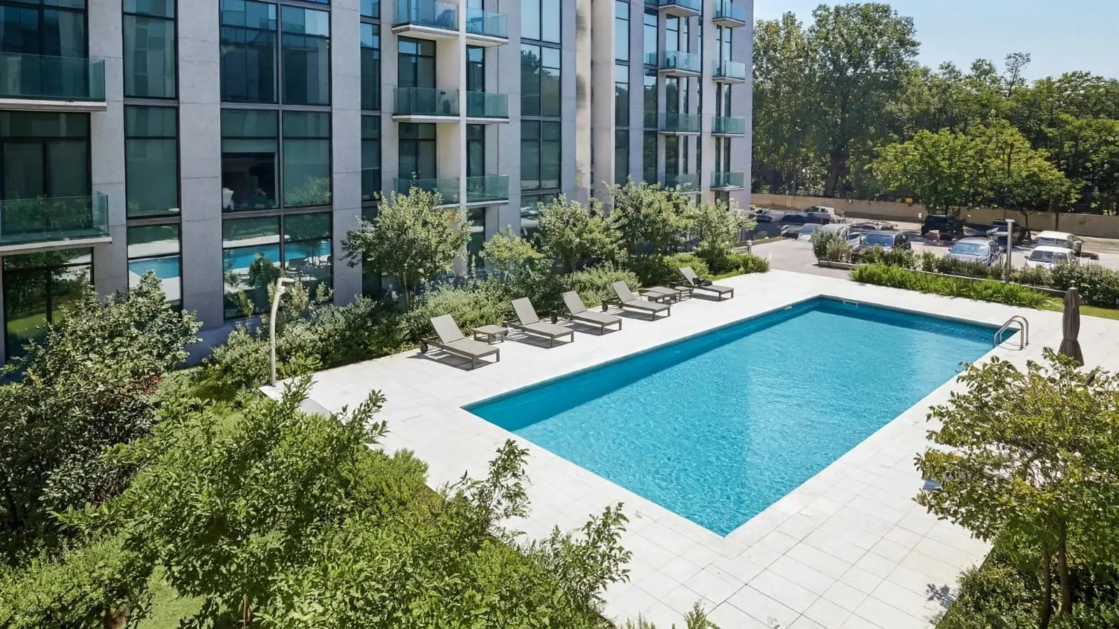 Nourwatan by Maskan features a modern outdoor swimming pool with leisure deck, perfect for family recreation, relaxation, and wellness living.
