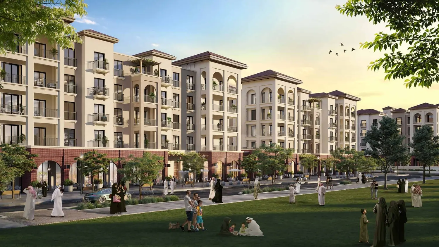 Evening exterior view of Granada apartment buildings illuminated within Bloom Living, Abu Dhabi community.
