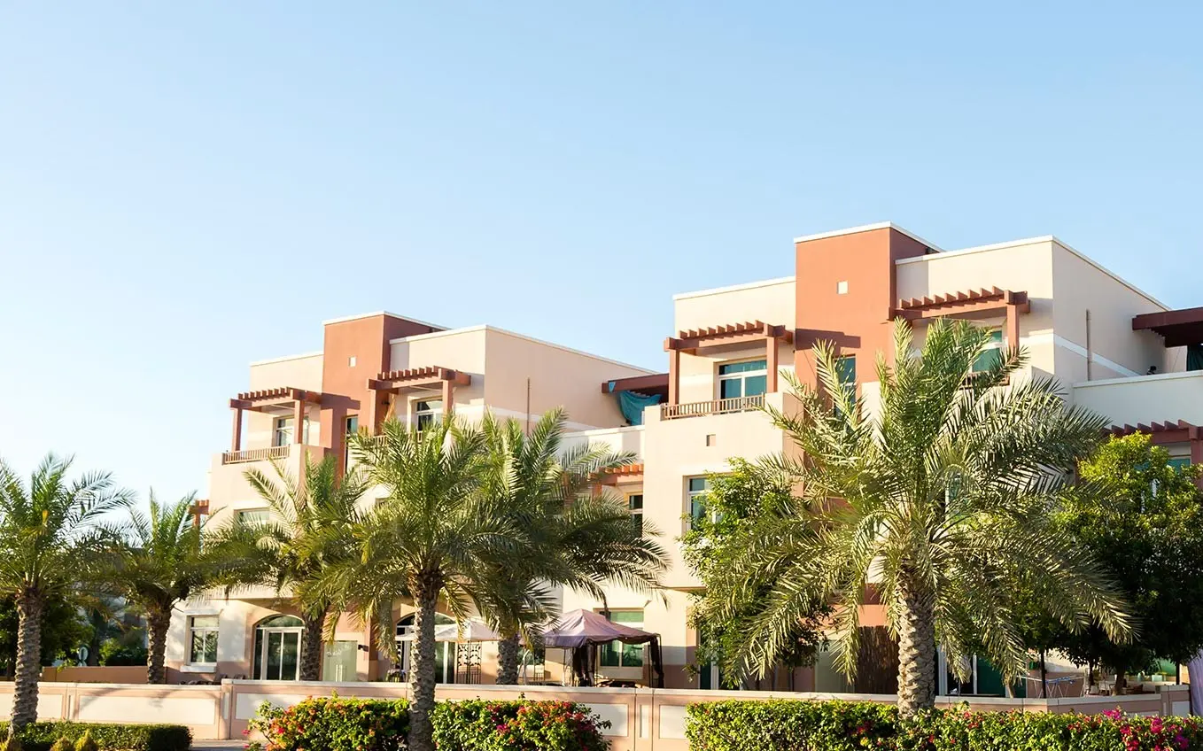 Residential streetscape in Al Ghadeer Abu Dhabi, UAE with shaded walkways and well-planned urban design..jpg