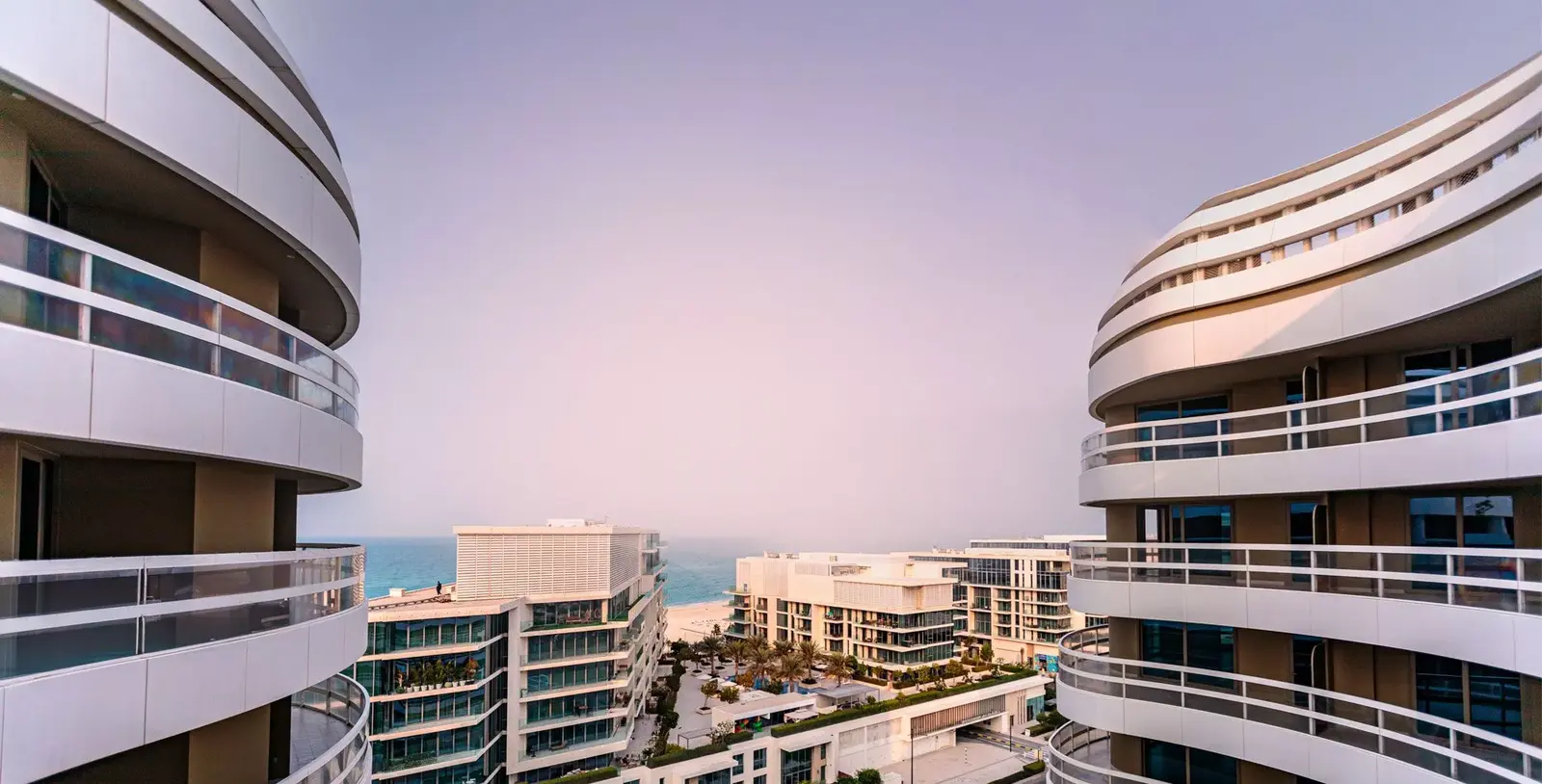 Modern facade of Ajwan Towers on Saadiyat Island with wave-like architectural curves and sea views in Abu Dhabi.