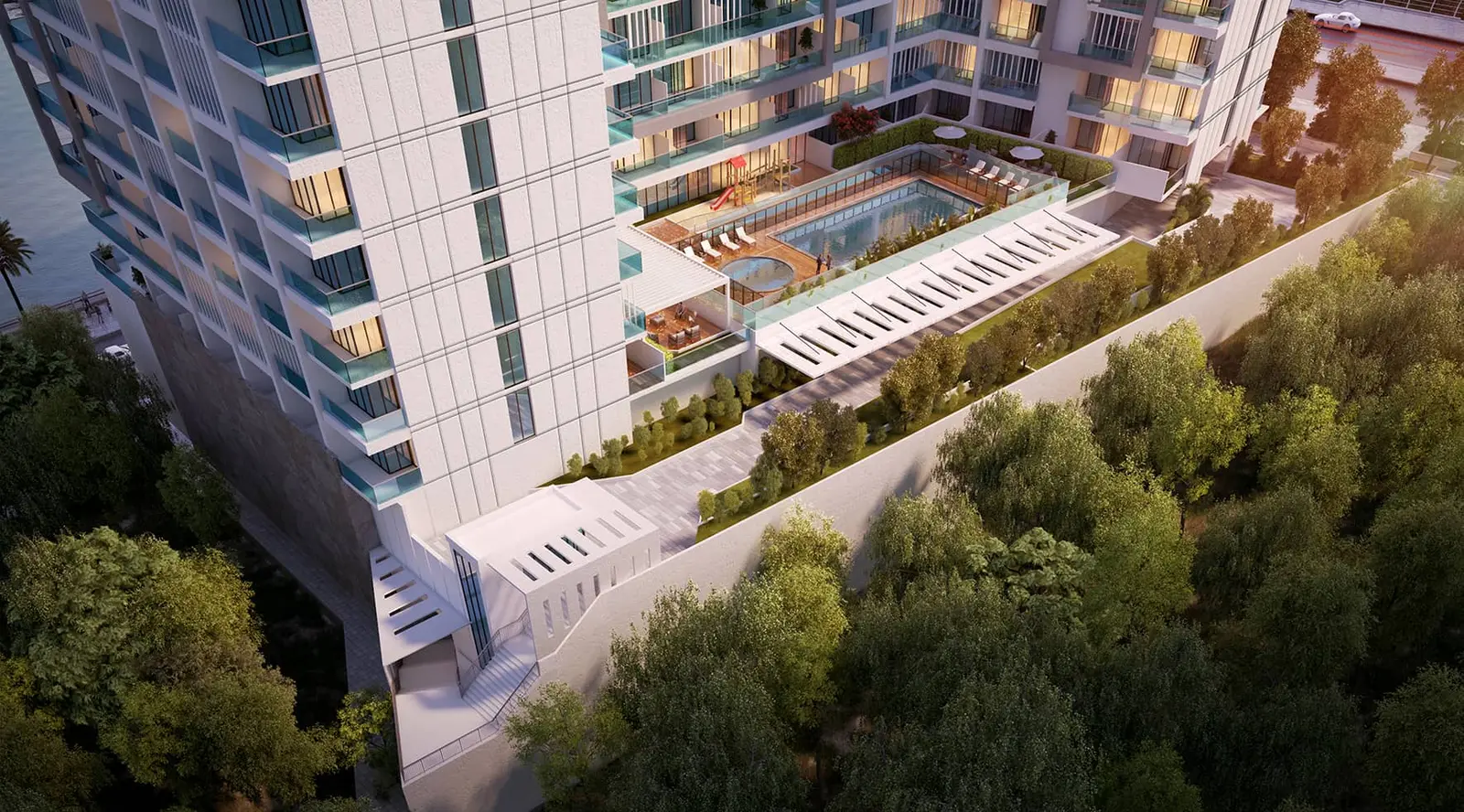 Al Maryah Island community pool area with sun loungers and landscaped gardens