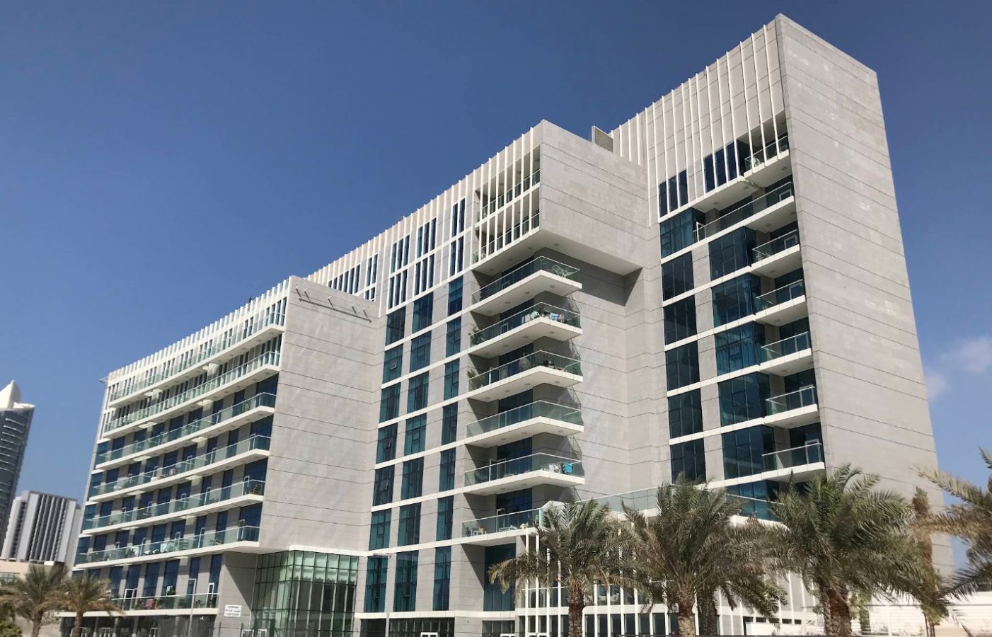 Modern low-rise exterior architecture and front entrance facade of By The Sea Tower in Shams Abu Dhabi, Al Reem Island, UAE.